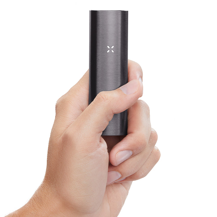 A womans hand holding the Black Pax 2 up close.