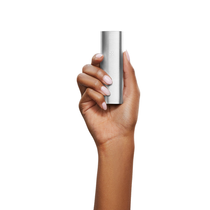 A womans hand holding the Platinum Pax 2.